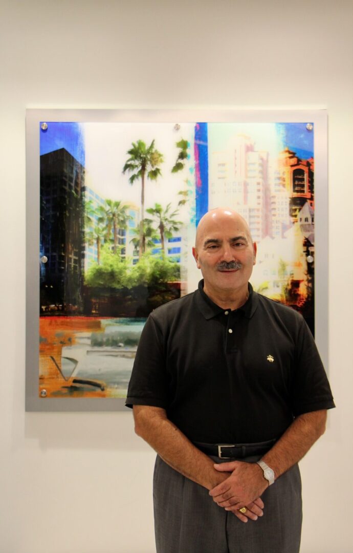 A man standing in front of a painting.